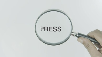 Press text or word highlighted by a magnifying glass in a hand on a white background, symbolizing focus on media, communication, publication, and the dissemination of information