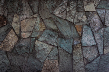 Textured Stone Mosaic Wall with Interlocking Patterns and Earthy Color Tones