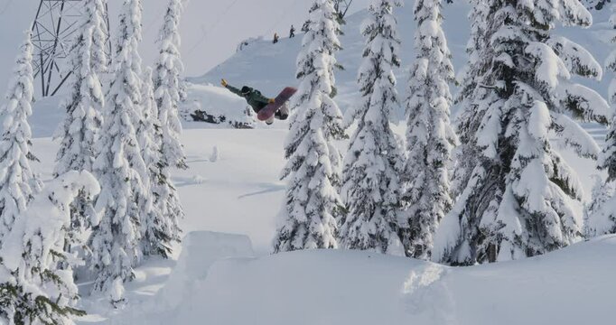 Snowboarder Tweaking Board Grab Off Backcountry Jump