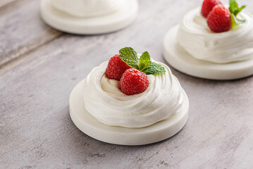 pavlova meringue dessert with raspberries and cream