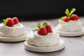 pavlova meringue dessert with raspberries and cream