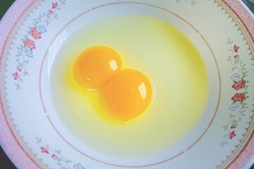 Fresh eggs in a white plate with beautiful patterns. Healthy food.