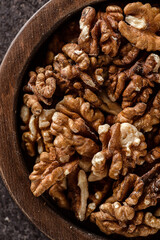 organic raw walnuts in a wooden bowl