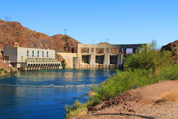 Hydroelectric Power Parker Dam beside transmission towers on the Colorado River and Lake Havasu, in Parker Dam, California, USA with blue sky copy space.