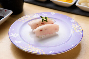 Raw fish sushi on a purple plate
