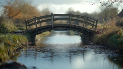 Fototapeta premium Eye-level view of a tranquil bridge over a serene countryside stream