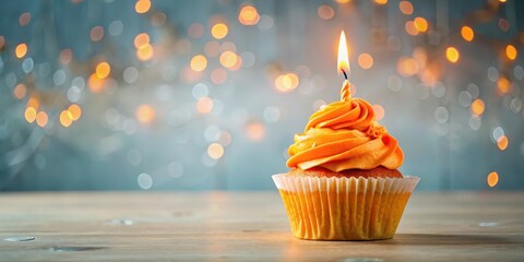 Brightly colored orange cupcake on a table with a sparkling candle on top, celebration, colorful,  celebration, colorful, sweet
