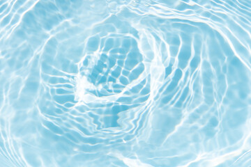 Blue water with ripples on the surface. Defocus blurred transparent blue colored clear calm water surface texture with splashes and bubbles. Water waves with shining pattern texture background.