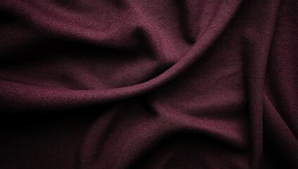 Fototapeta premium A textured and draped fabric in a deep reddish purple color