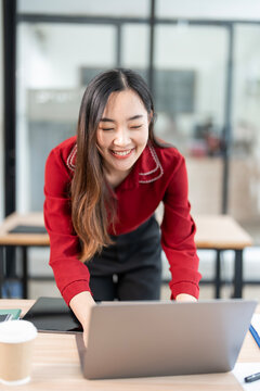 Creative young asain woman working on laptop in her studio