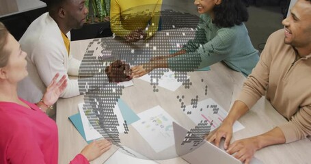 Diverse team collaborating at table with digital globe animation overlay - Powered by Adobe