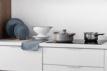 Cooking pots on stove in modern kitchen