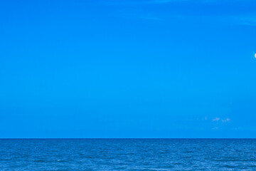 Nature of the beach and sea Summer with sunshine, sandy beaches, clear blue waters sparkling against the blue sky. On an island with good ecology and environment Background for summer vacation