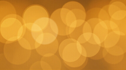 Warm yellow bokeh lights glowing softly on a dark, blurry background, creating a serene and dreamy atmosphere.