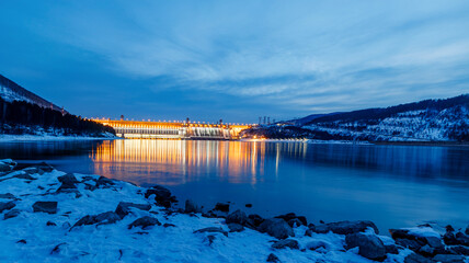 View of a hydroelectric dam on a river, long exposure photography at dusk