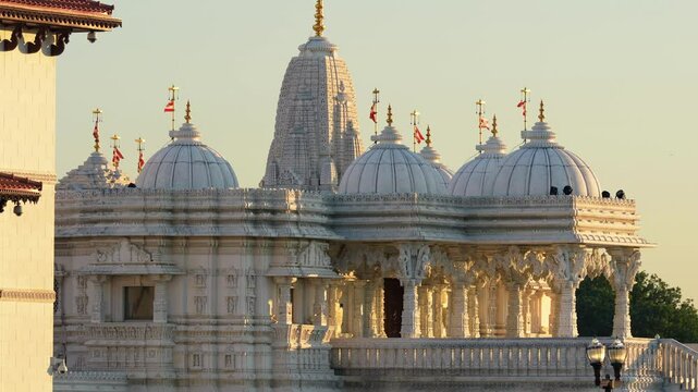 BAPS Shri Swaminarayan Mandir Hindu temple in Toronto at sunset with golden sky
