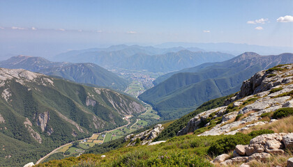 Mountain view with lush valleys and distant hills