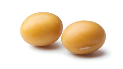Two yellow dry soybean seed isolated on white