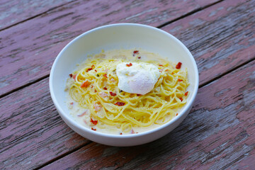 Creamy spaghetti carbonara served in a white bowl