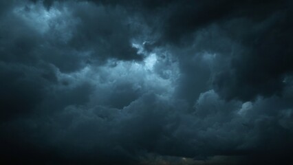 Ominous and dramatic dark stormy sky with billowing clouds and a soft glow creating an eerie atmosphere.