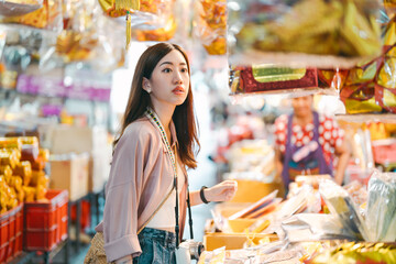 Woman solo travel at chinese local culture market product at shop vendor