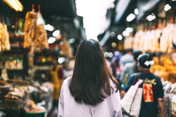 Rear view of woman explore at chinese local culture market traditional street