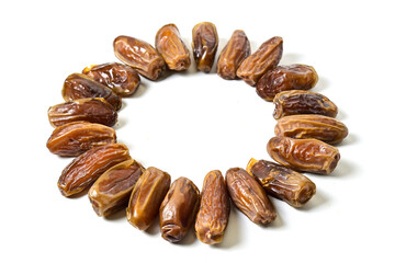 Close up view of kurma tunisia or sweet dried dates palm fruits in circle shape isolated on white background. Clipping path.