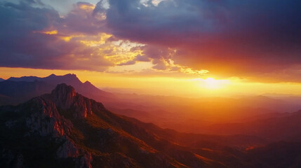 Fototapeta premium Majestic mountain range sunset dramatic golden hour landscape view sky red light hills peaks rocks