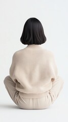 Obraz premium back view. model woman sitting on floor Over white Studio Background.