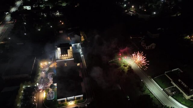 Aerial footage of a fireworks display in the backyard of a hotel at night in Ramnicu Valcea, Romania