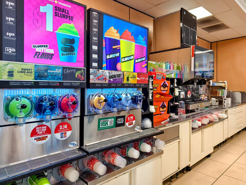 Inside a 7-Eleven convenience store featuring a range of slush and snack options.