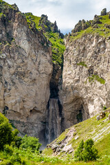 waterfall among the mountain rocks