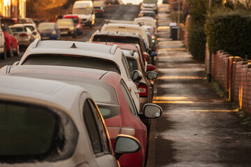 Frost snow covered british road and cars in england uk