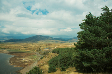 landscape with lake, clouds and mountains
