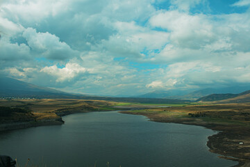 landscape with lake, clouds and mountains