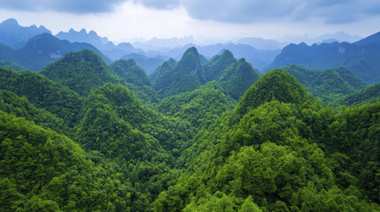Fototapeta premium Lush green mountains create stunning aerial view of serene landscape, showcasing nature beauty and tranquility