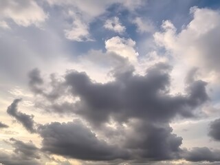 Fototapeta premium Dramatic Cloudscape Fluffy Gray Clouds Against a Blue Sky, Weather Background, Natural Beauty, Atmospheric.