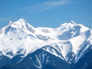 Obraz premium Majestic Snowy Mountain Peaks Under a Clear Blue Sky - Stunning Landscape Scenery for Travel, Adventure, and Nature.