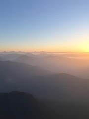 Obraz premium Majestic Mountain Range at Sunrise, Foggy Valley, Sky, Nature Scenery, Travel Landscape.