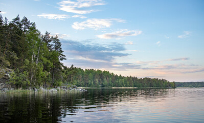 A lake with a cloudy sky in the background