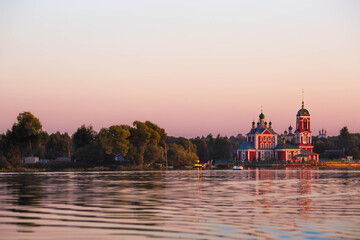 Fototapeta premium The Golden Ring of Russia, the city of Pereslavl-Zalessky. The Church of the Forty Martyrs of Sebaste at a beautiful pink sunset on the side of Lake Pleshcheyev.