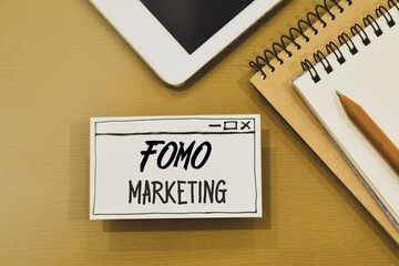 FOMO Marketing inscription on hand drawn web browser paper on office desk. Business marketing strategy using consumer's fear of missing out on exclusive opportunities to drive engagement and sales.
