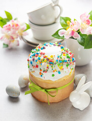 Traditional easter cake decorated with colorful sprinkles, eggs, and flowers