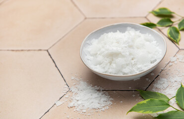 Magnesium flakes in a bowl for a relaxing bath promoting wellness and skincare