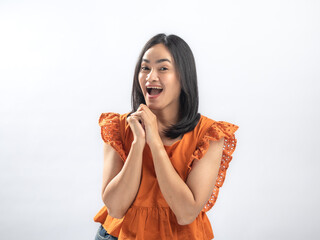 Delighted Southeast Asian woman with straight black hair in orange ruffled blouse and jeans,...