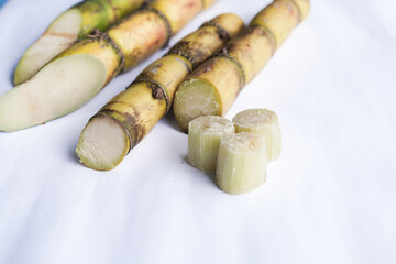 A bunch of sugar cane is cut into small pieces