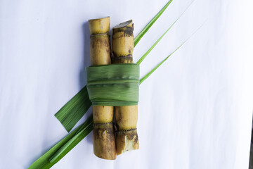 A bunch of sugar cane is cut into small pieces