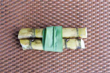 A bunch of sugar cane is cut into small pieces