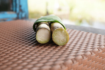 A bunch of sugar cane is cut into small pieces