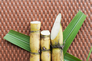 A bunch of sugar cane is cut into small pieces